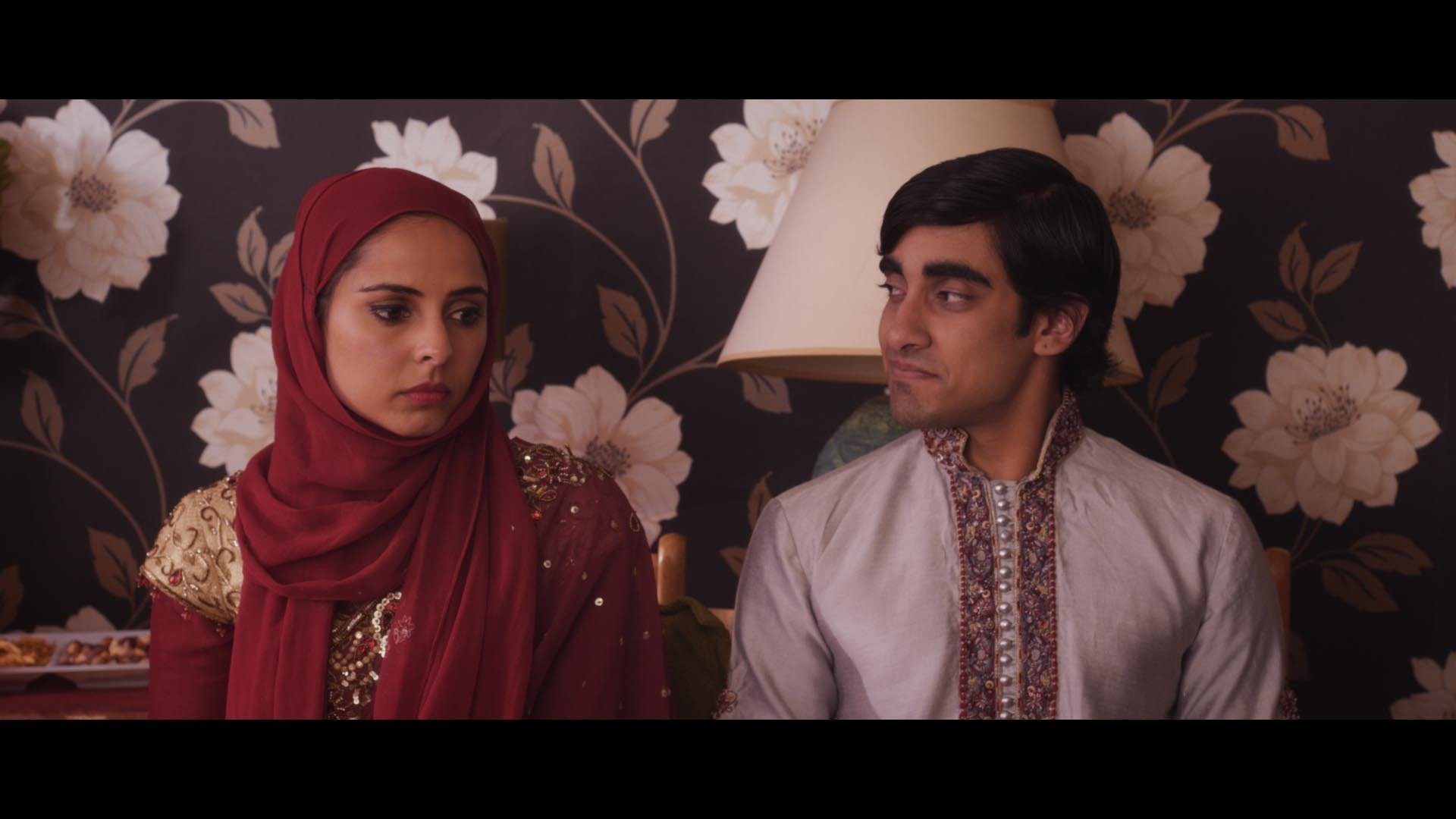 Sakeena (Reena Anjali) looks on worried as her family announce her engagement to Rome (Ali Storm) in Callum Andrew Johnston's The Forbidden Note.
