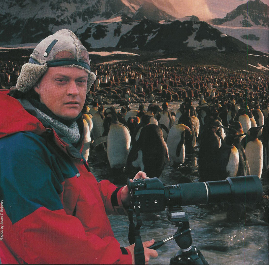 Jason Roberts with King Penguins on the island of South Georgia, sub Antarctica.
