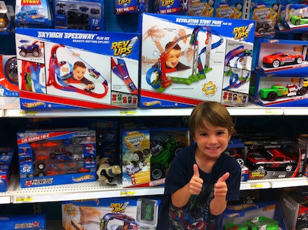 Aiden at the toy store seeing himself on the Hot Wheels toy box cover!