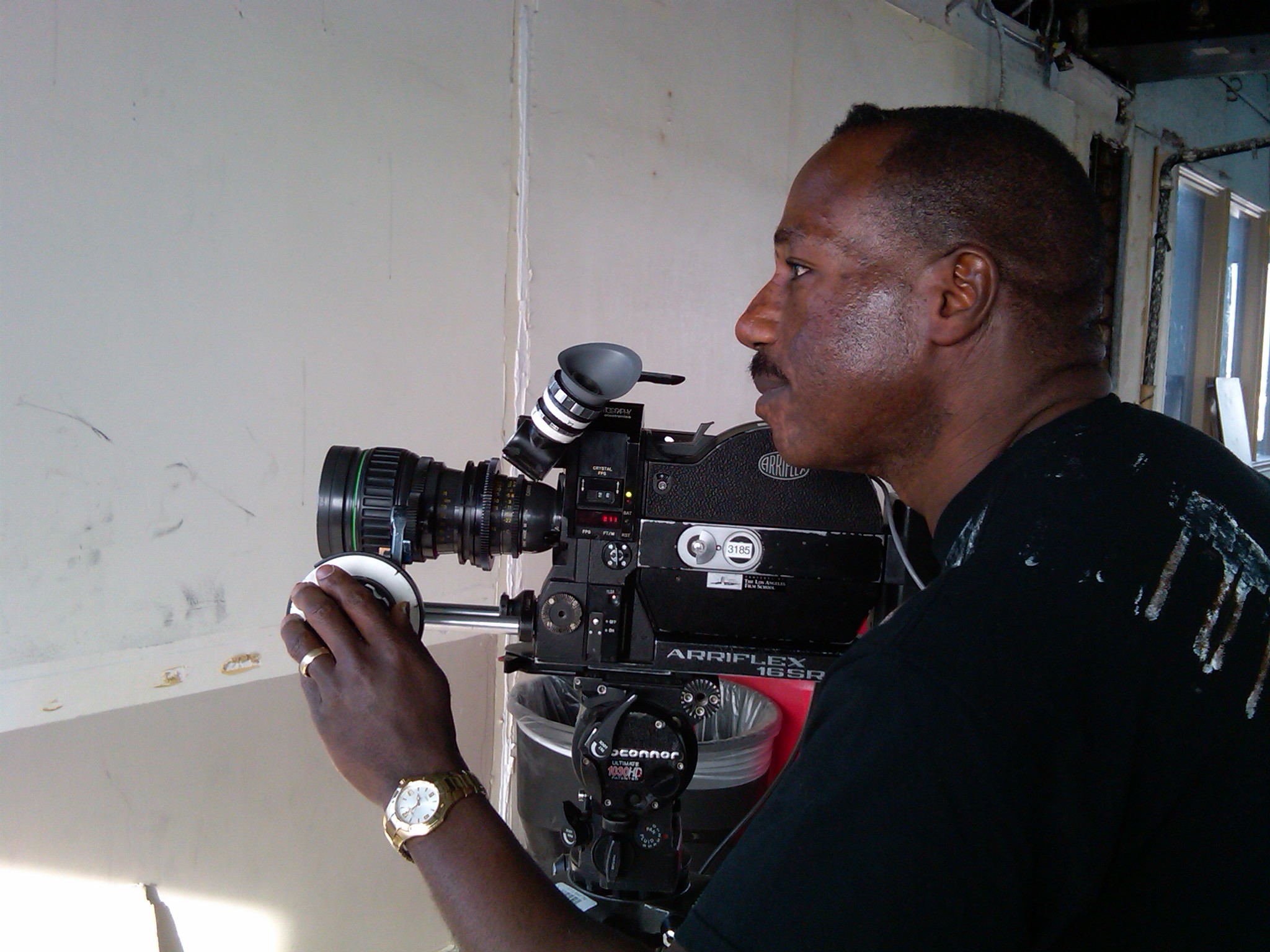 Director Bruce B. Gordon making adjustments on an Arri-SR2 Super 16mm film camera during a shoot in Los Angeles.