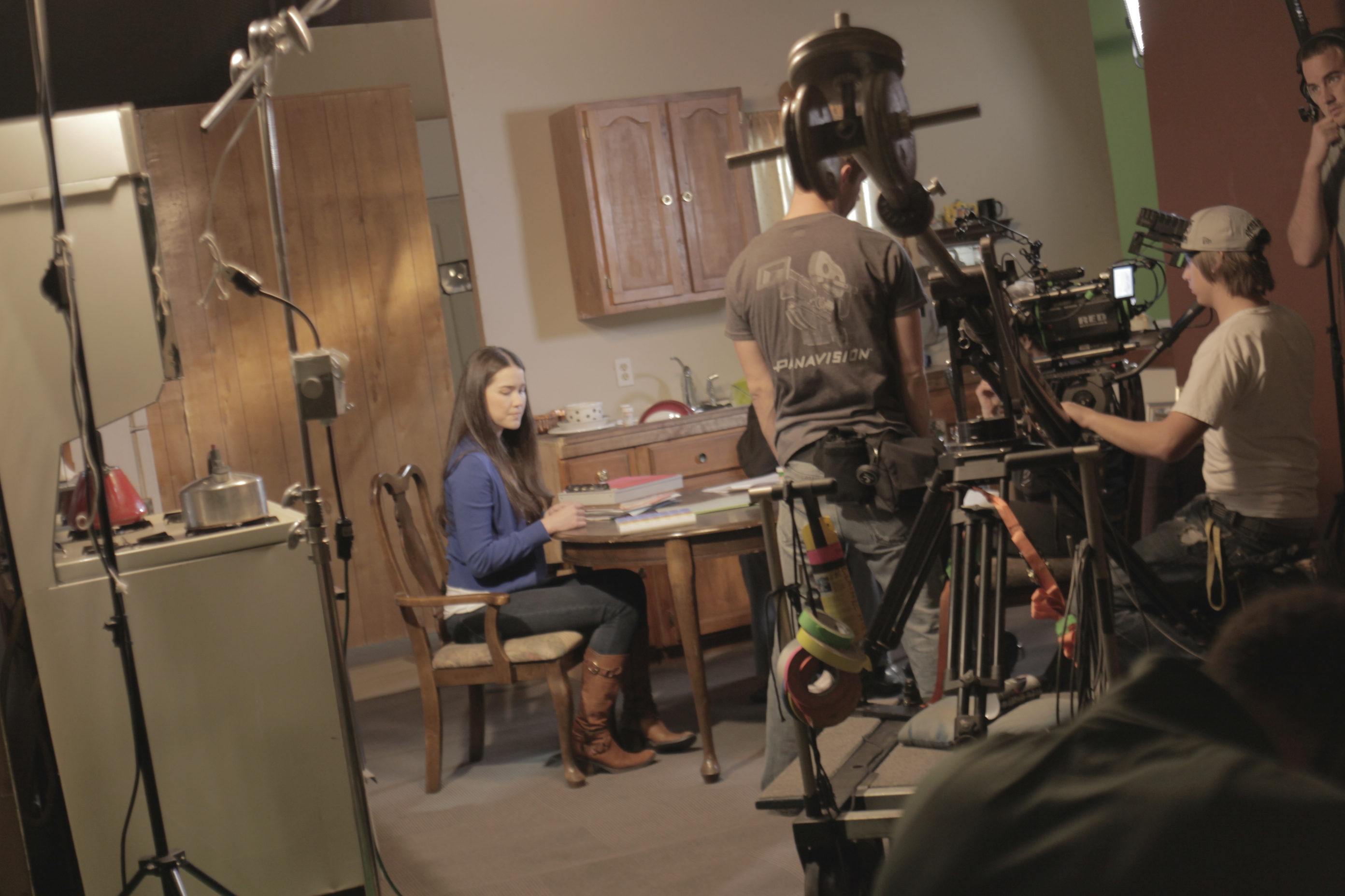 Actress Achara Kirk studies her lines while the crew sets up the equipment to get the next shots that director Bruce B. Gordon blocked.