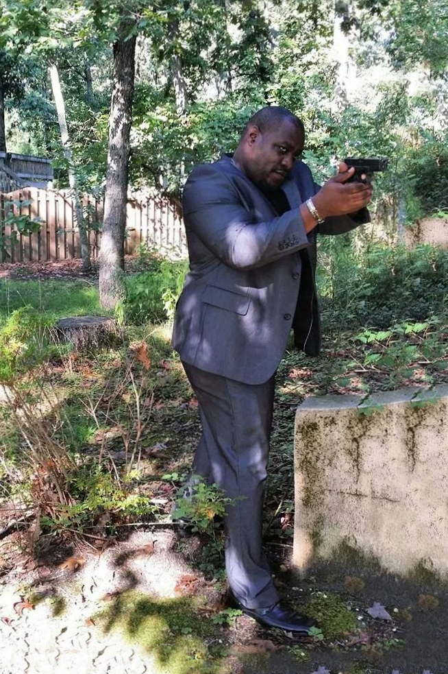 Actor Therron Dumas taking aim at an assailant in 