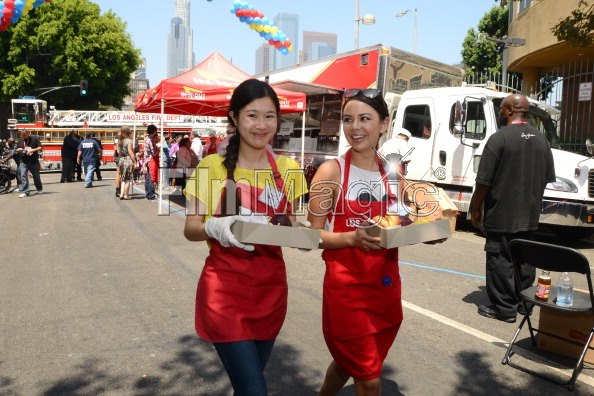 Actress Tina Q. Nguyen and actress Jarel Parrish (Pretty Little Liars) volunteers at the Los Angeles Mission's End of Summer Block Party on August 25, 2012