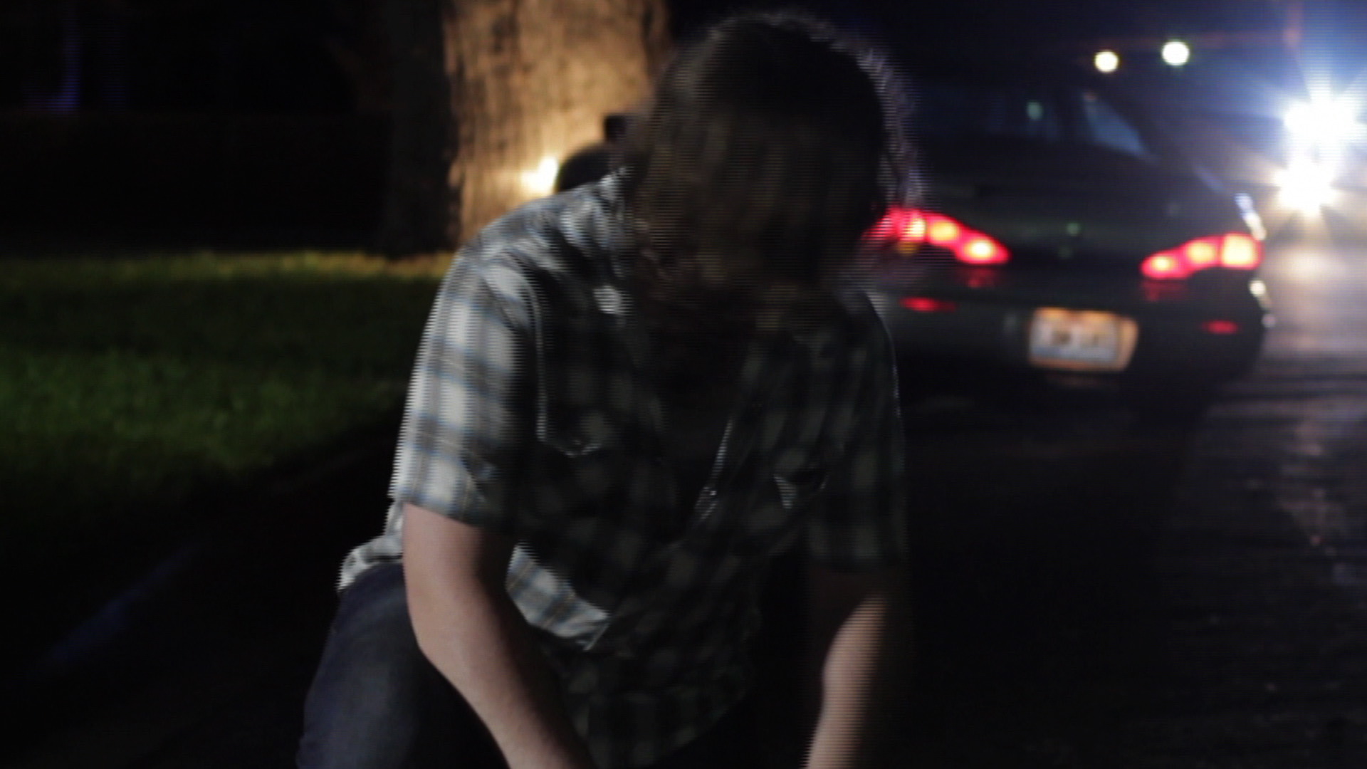 Jon Brewer sees the cops are coming as he leans over Jake's body in a scene from 