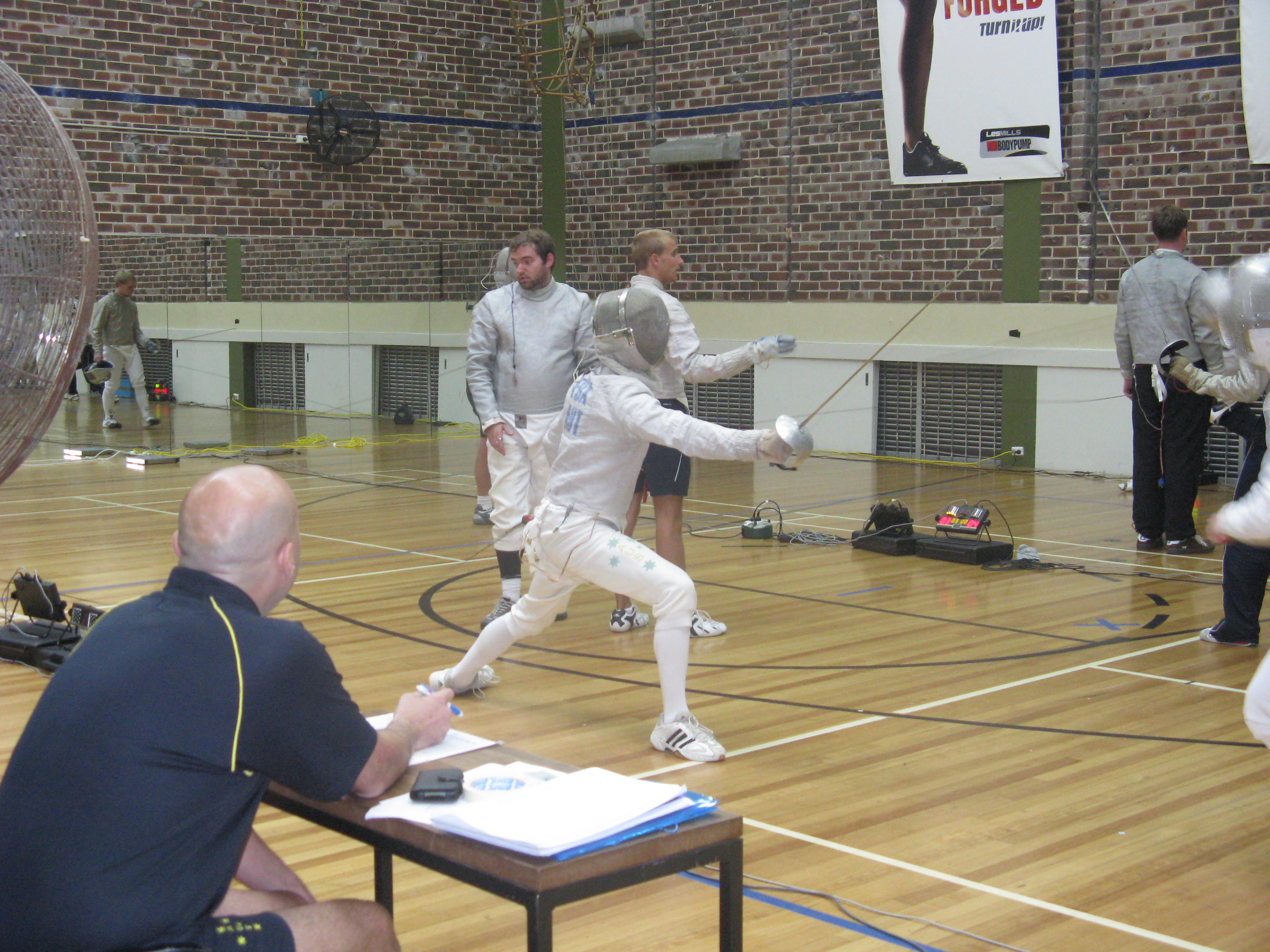 David Ehrlich Fencing with Sabre in Middle of Picture