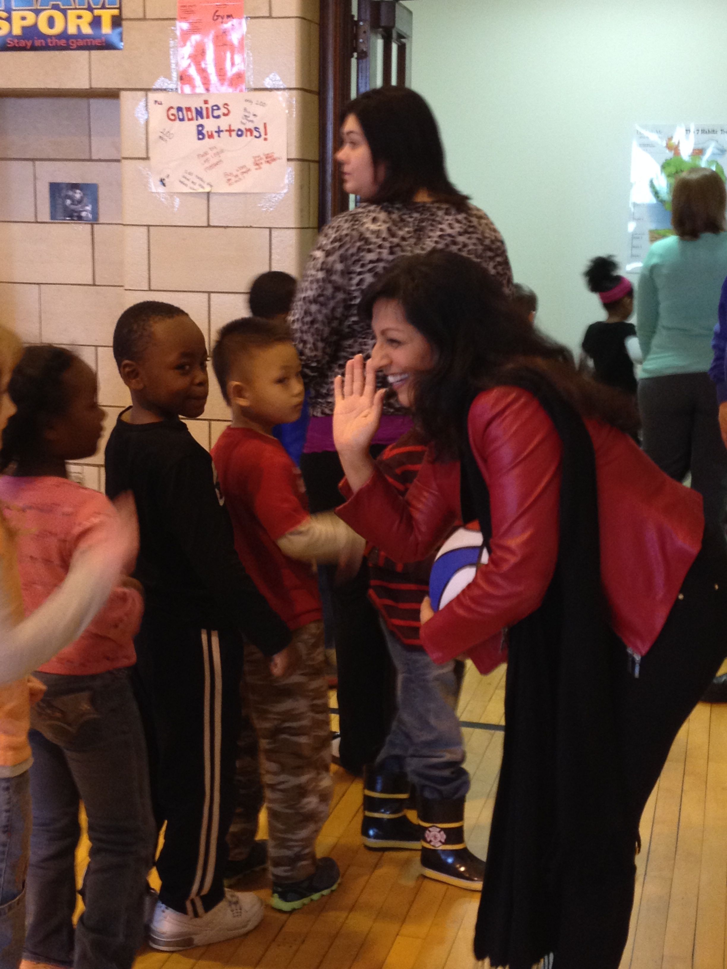Gabriella greets children after assembly.