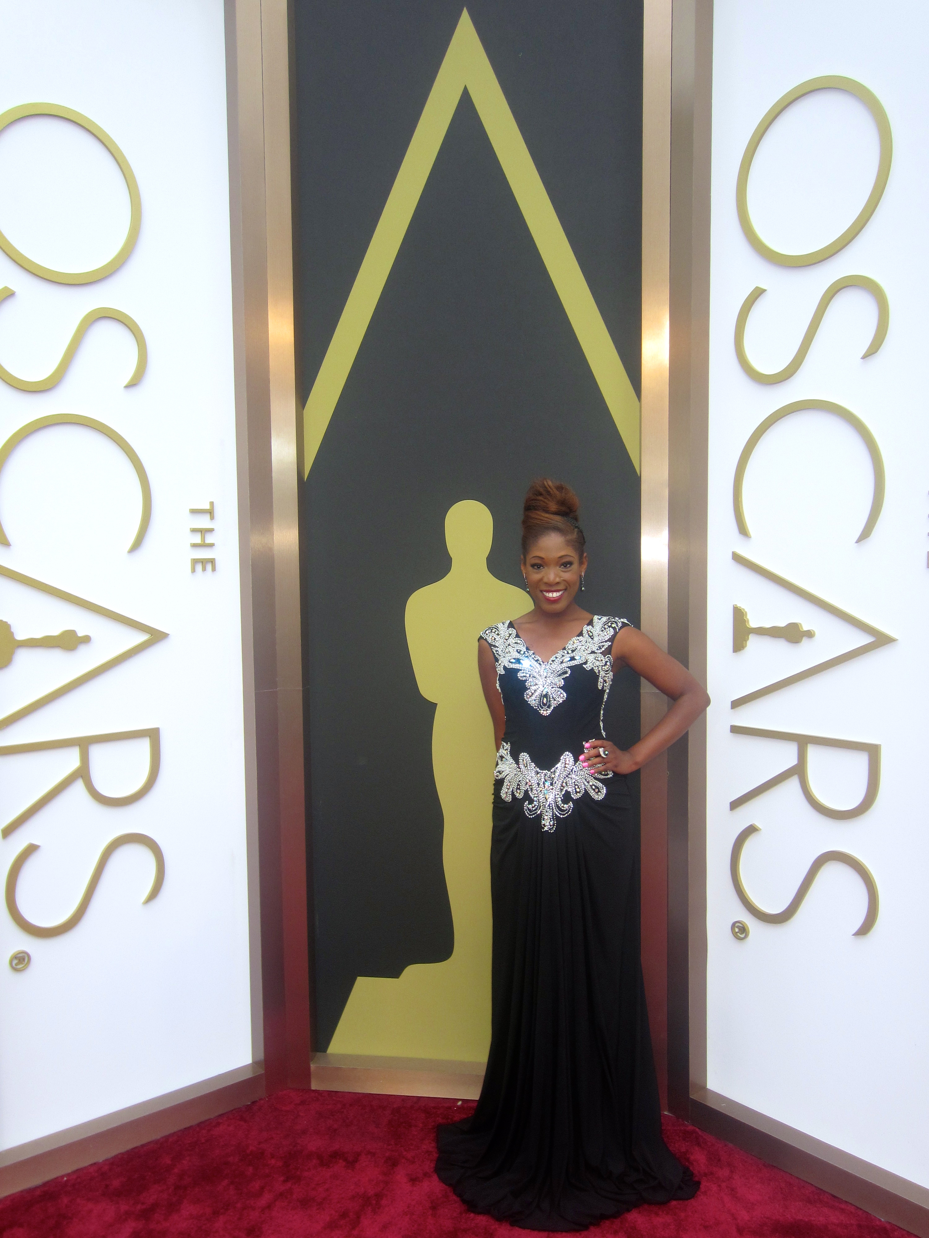 Host Tysha Williams of Studio 3 Hollywood LIVE at the 56th Annual Academy Awards Red Carpet Arrivals. In designer Shekhar Rehate gown and American Gem Company jewelry
