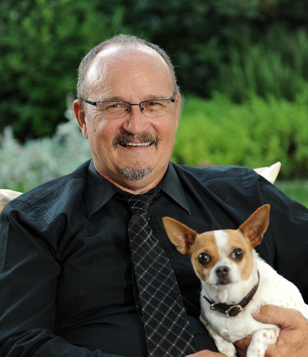 W. Mark Dendy at home with his dog Pancho Via.