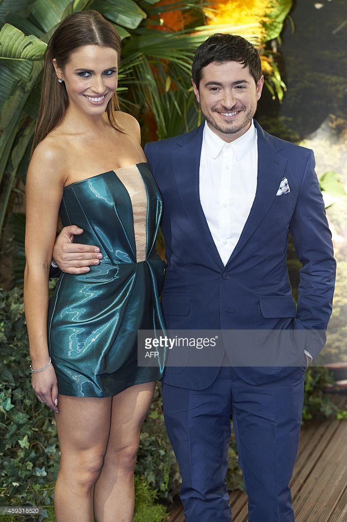 Alexandra Siegel poses for photographers as she arrives with screenwriter Jason Fuchs for the World Premiere of 'PAN' in London's Leicester Square on September 20, 2015.