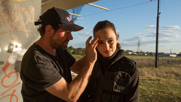 Chris Wells applies a quick cosmetic wound to Aurora.