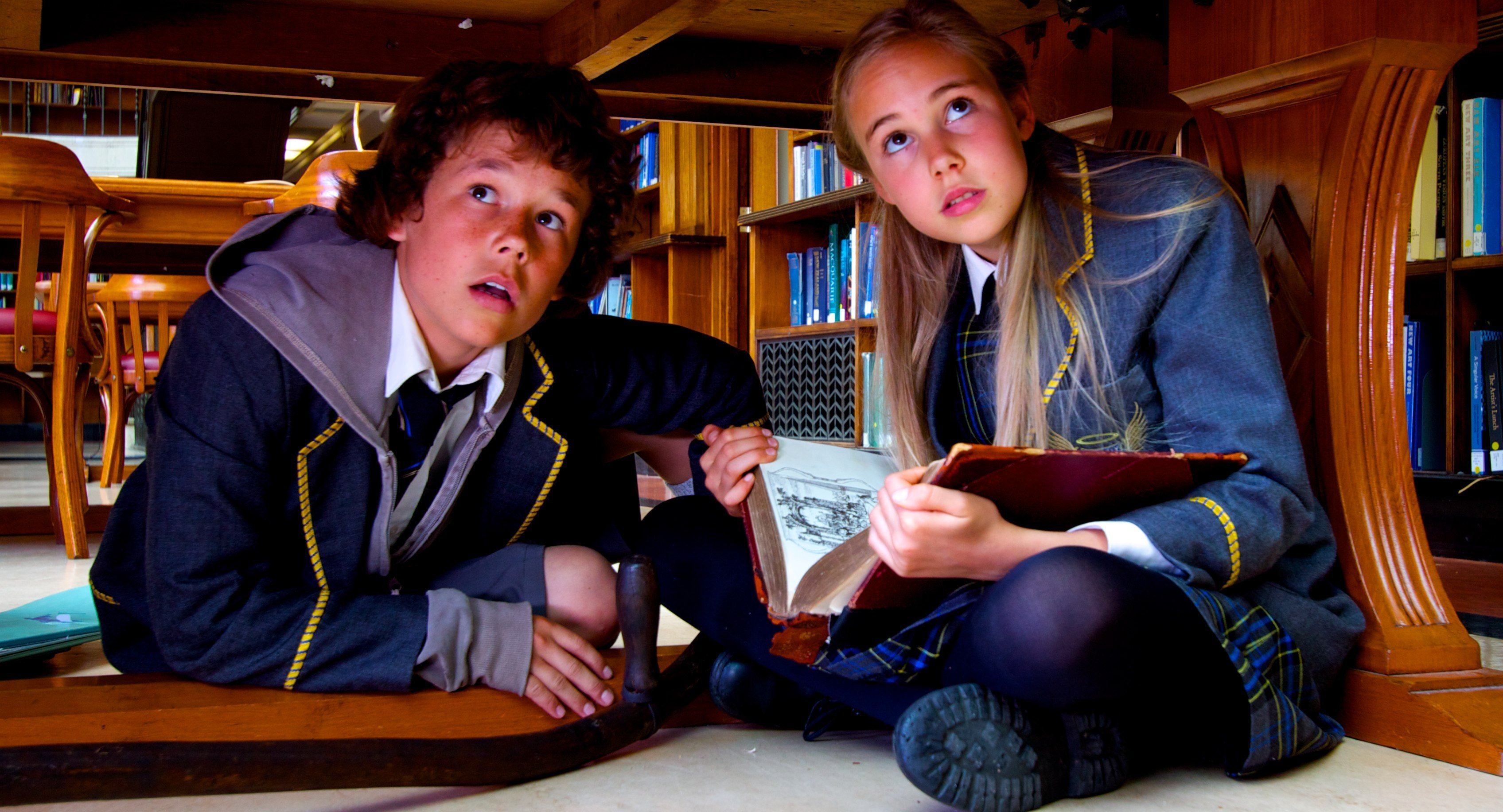 Ed (Joel Barker) and Grace (Olivia Eastwood) hide in Divinity's Great Library.