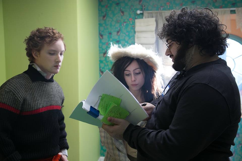 Michael William Hunter and Allisyn Ashley Arm talking to director, Hooroo Jackson, on the set of 