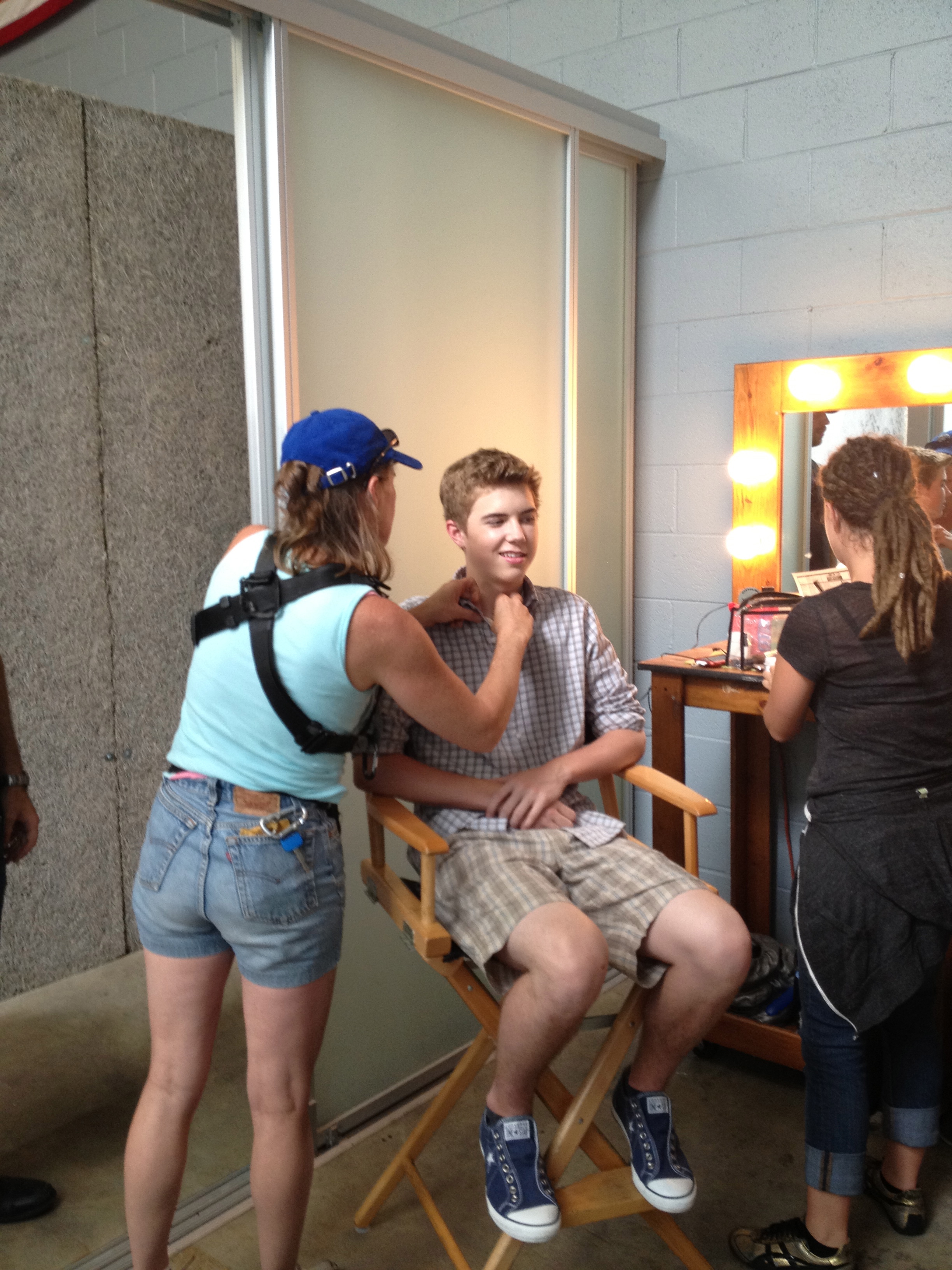 Alex Reininga getting make up done and getting his mic put on at the same time