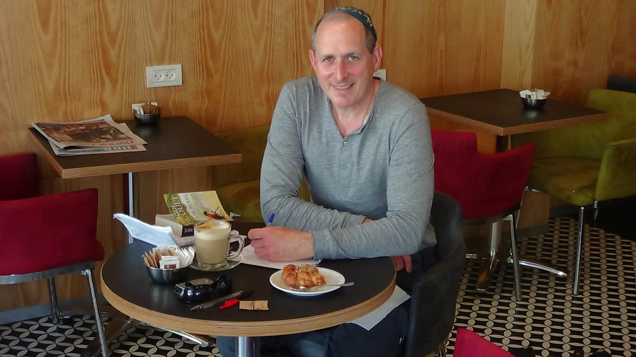 Lowell Joseph Gallin at his favorite cafe in Tel Aviv engaged in some of his favorite activities: drinking coffee, eating cake and doodling (with his new rapidograph