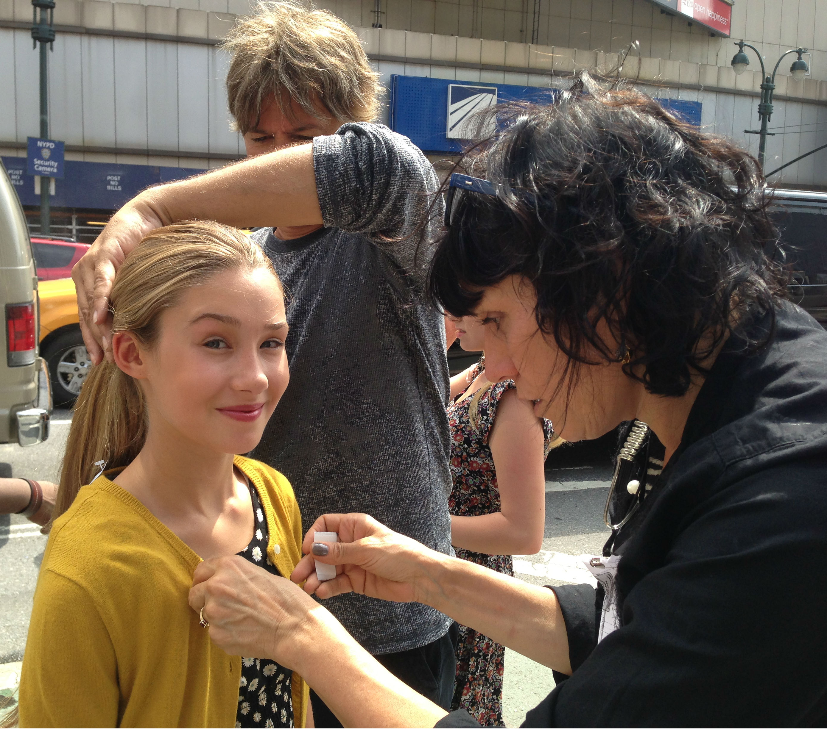 Kylie getting help from hair and wardrobe on the CBS set of 