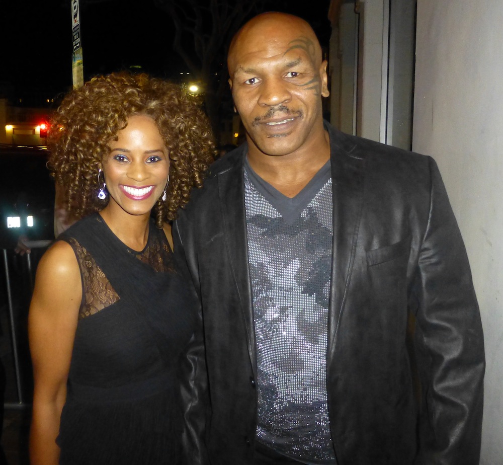 Host Germany Kent attends the Premiere of Draft Day in Westwood, pictured with Iron Mike Tyson