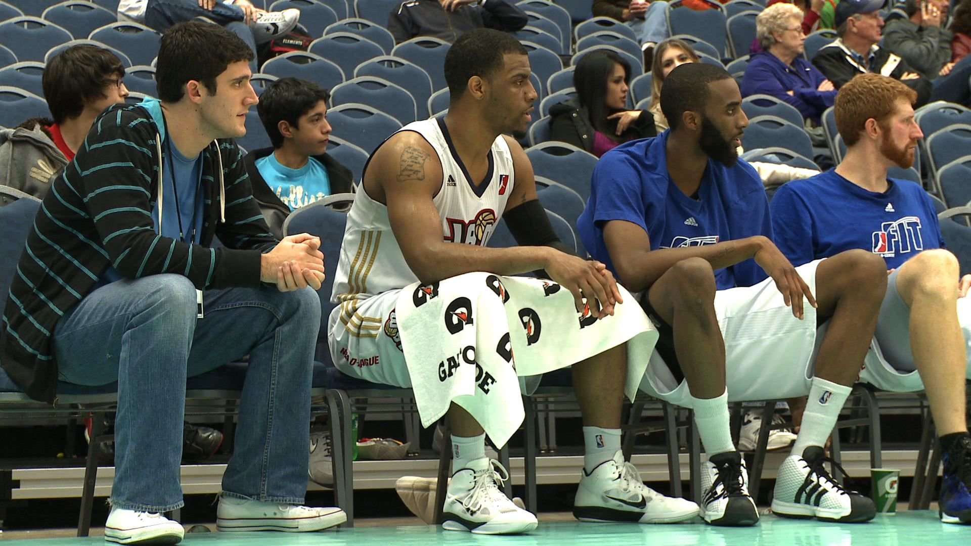 Jeff Camarra and Trey Johnson sit on the bench during the 2011 NBA D-League Showcase.