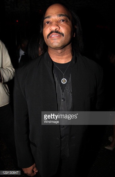 Dennis poses for Getty Images at film premiere.