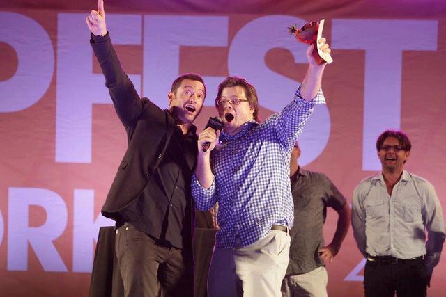 Hugh Jackman and 2012 Tropfest NY Winner Josh Leake sing on stage during his acceptance speech.