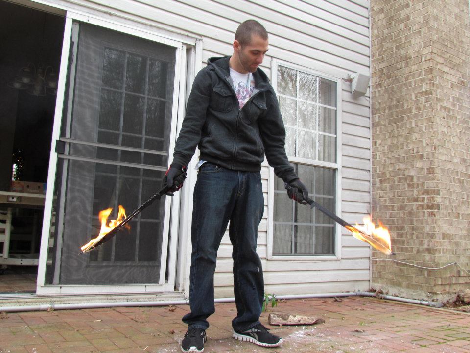 Cliff getting used to holding flaming swords for his role in Fleece as Ignis