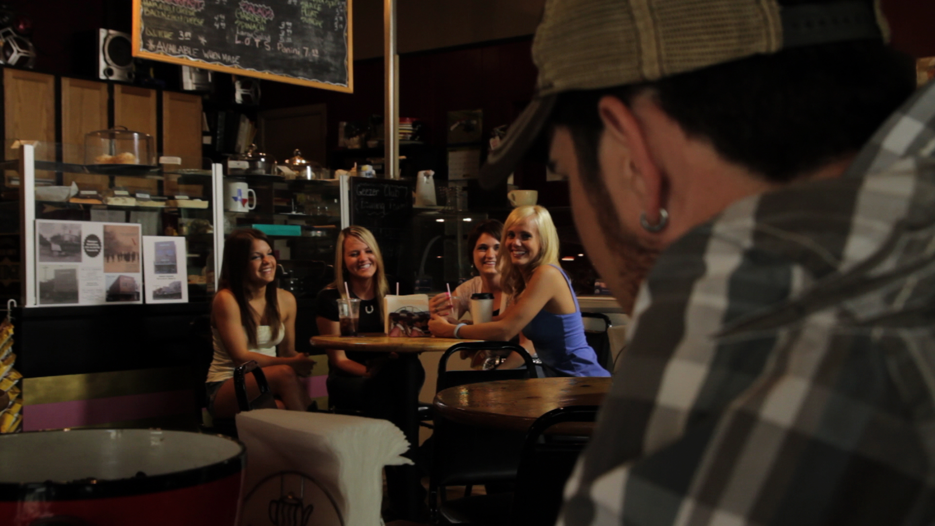 Neil Austin Imber looking over at girls who are eyeing him in a scene from 