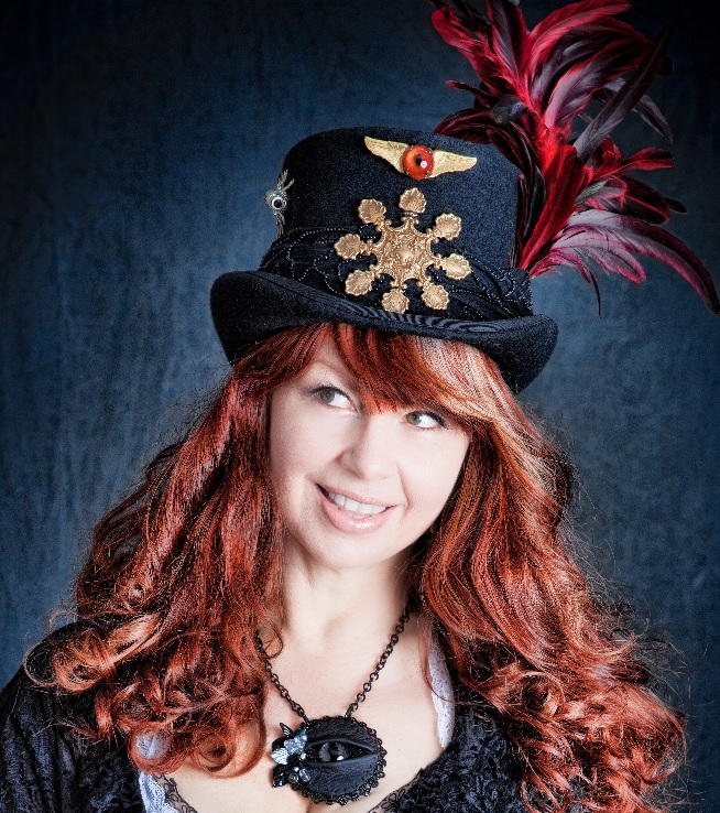 Dr Brassy Steampunk Jewelry and Hat Maker wearing one of her hats and a LaGrand Sightmares  © Eye Necklace.