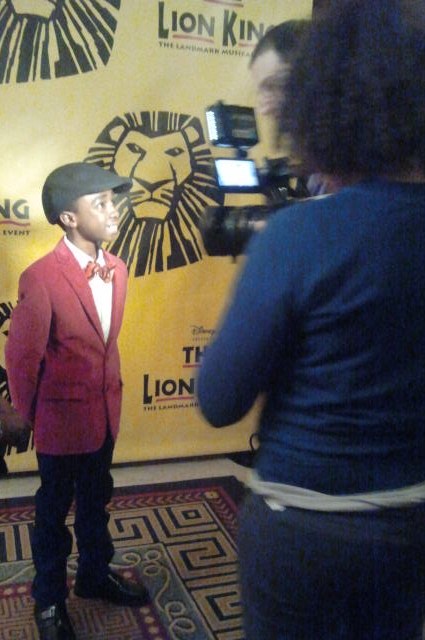 Caleb being interviewed for at the Lion King 15th Anniversary Celebration