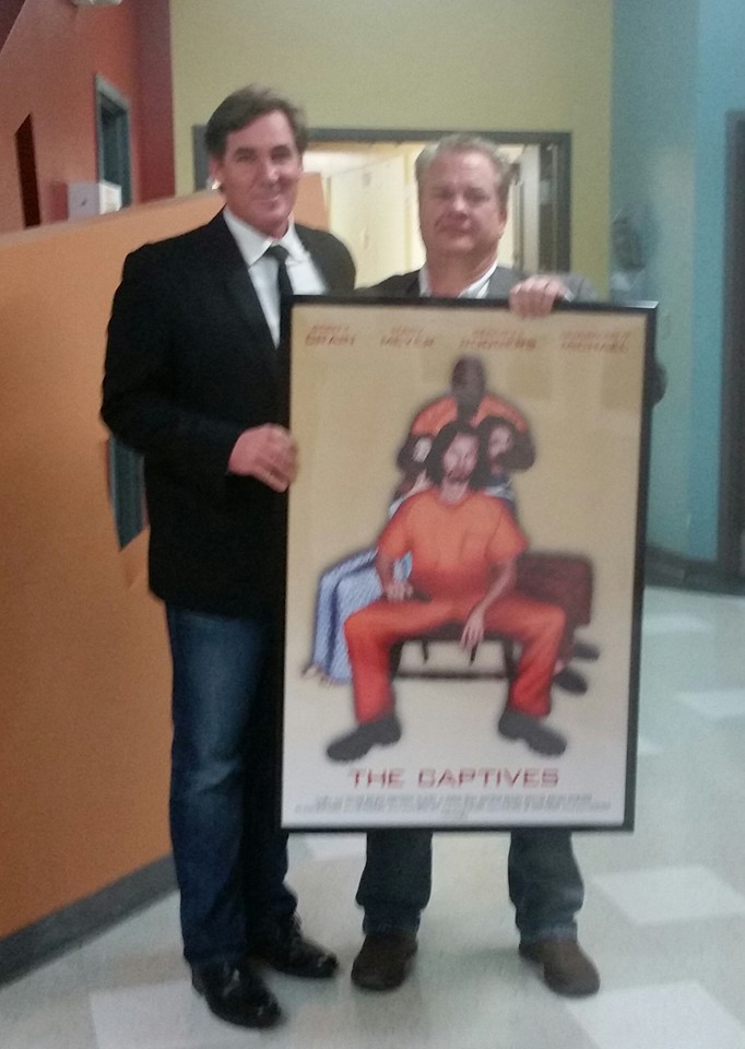 Joseph Wilson with Director/producer Allen carver holding the movie poster of 