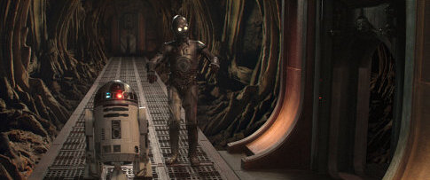 The droid odd couple, R2-D2 and C-3PO search for their masters down a long corridor in a droid factory on the planet Geonosis