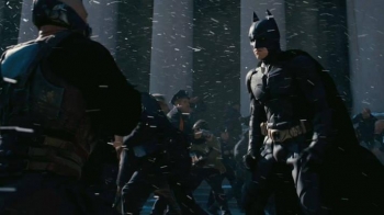 From The Dark Knight Rises, I am the police officer in the orange-lined raincoat between Bane and Batman. Screen shot from TDKR trailer two.