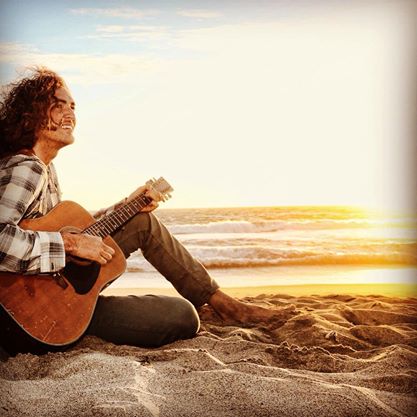 Preston Gazowsky playing a tune at the beach.