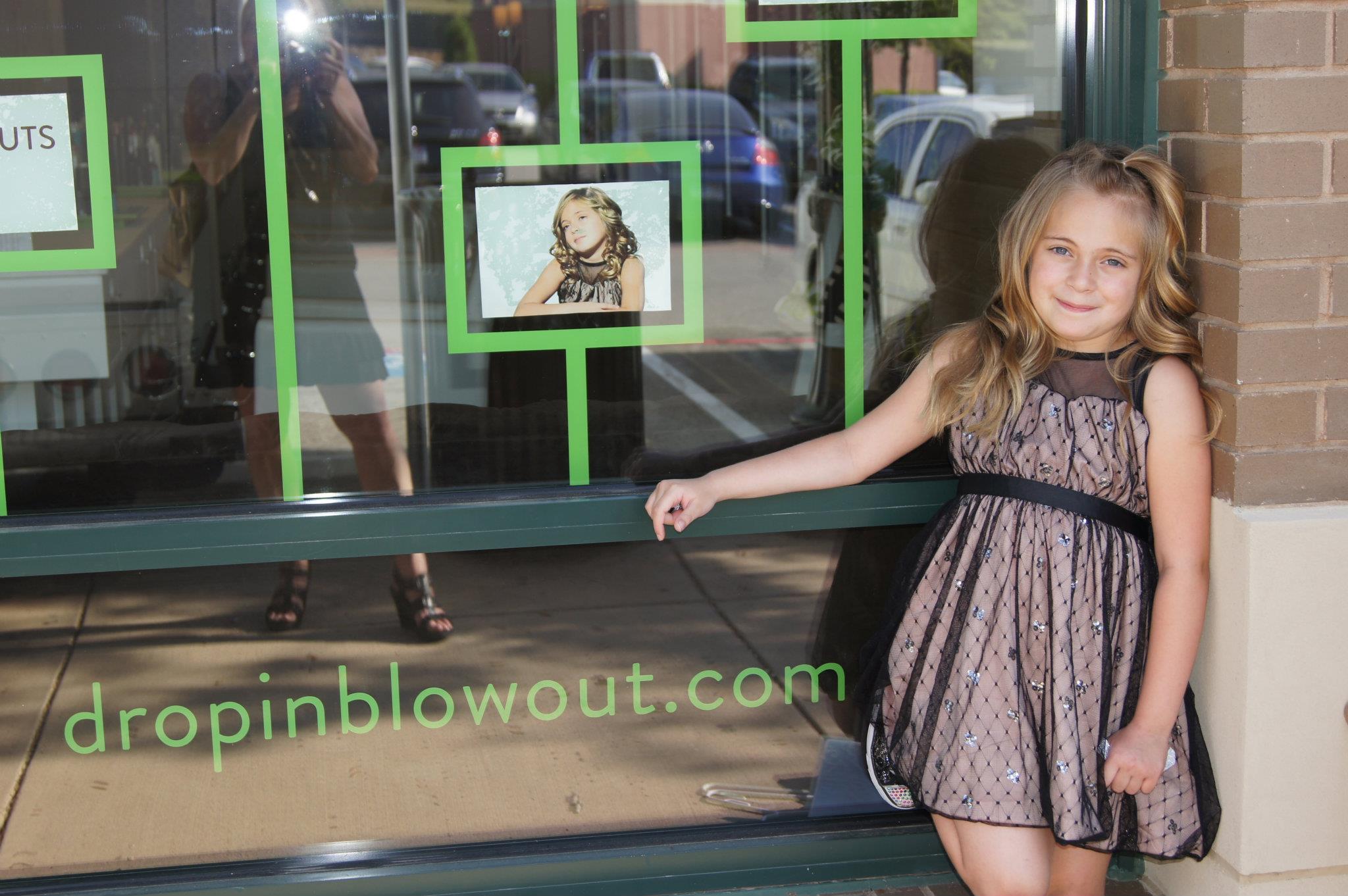 This is Tatum Jade outside of The Hair Bart store where she is featured on the store front graphics.