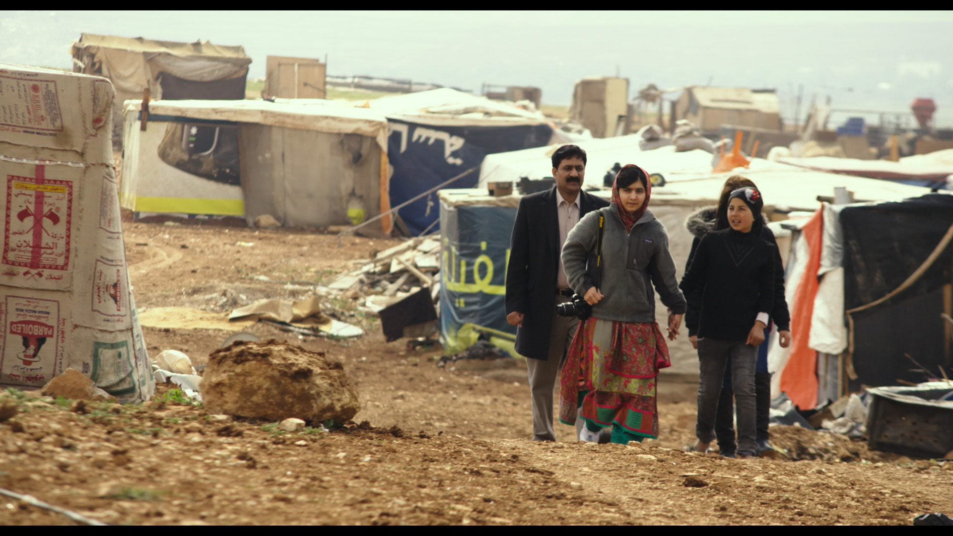 Zia Yousafzai and Malala Yousafzai and Syrian refugee Rimah in Syrian Refugee Tent Camp in Jordan.