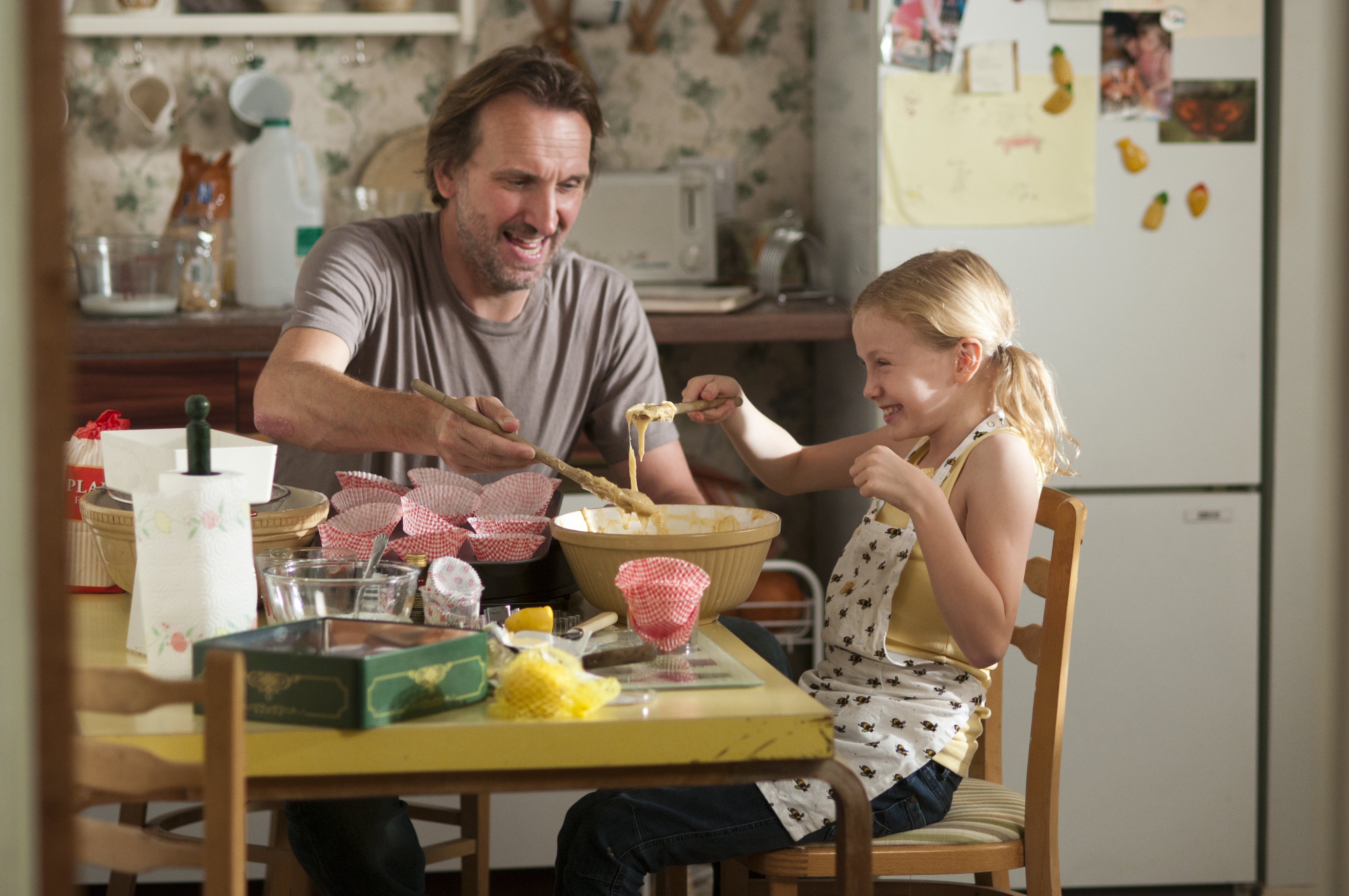 Jennifer (Orla Hill) and James (Christopher Eccleston) making cakes