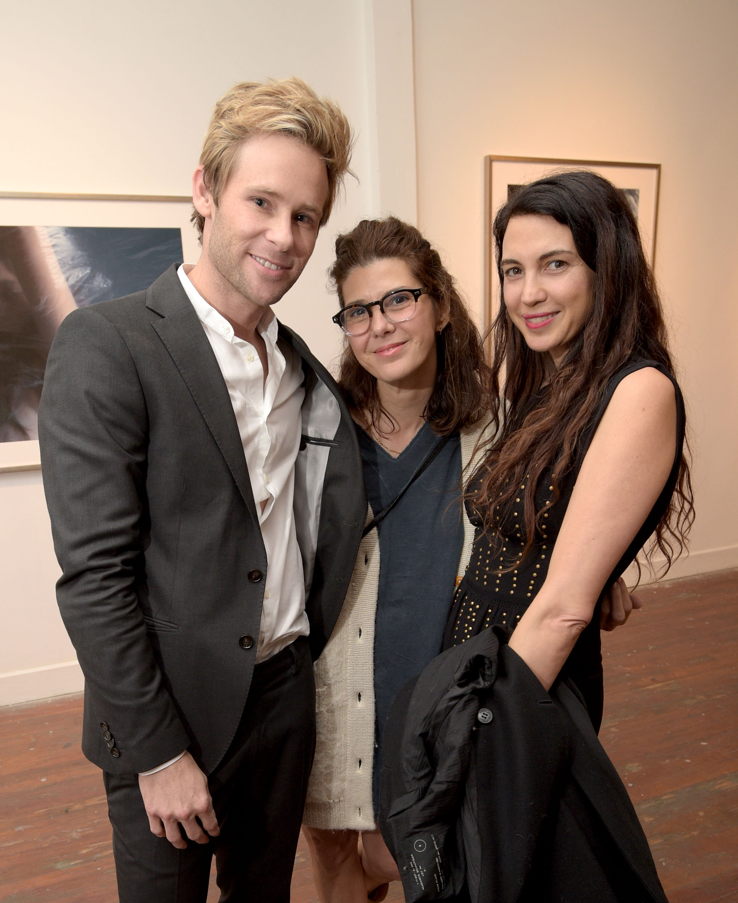 LOS ANGELES, CA - MAY 09: (L-R) Artist Bryan Fox, actresses Marisa Tomei, and Shiva Rose attend We. Alone. a photography exhibit by Bryan Fox at Think Tank Gallery on May 9, 2015 in Los Angeles, California.