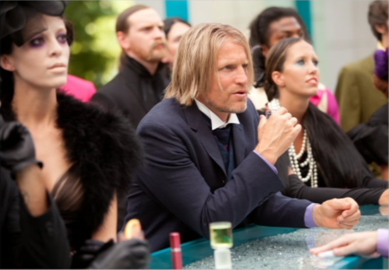 Amanda Dunn shares the screen with Woody Harrelson in a scene from The Hunger Games.
