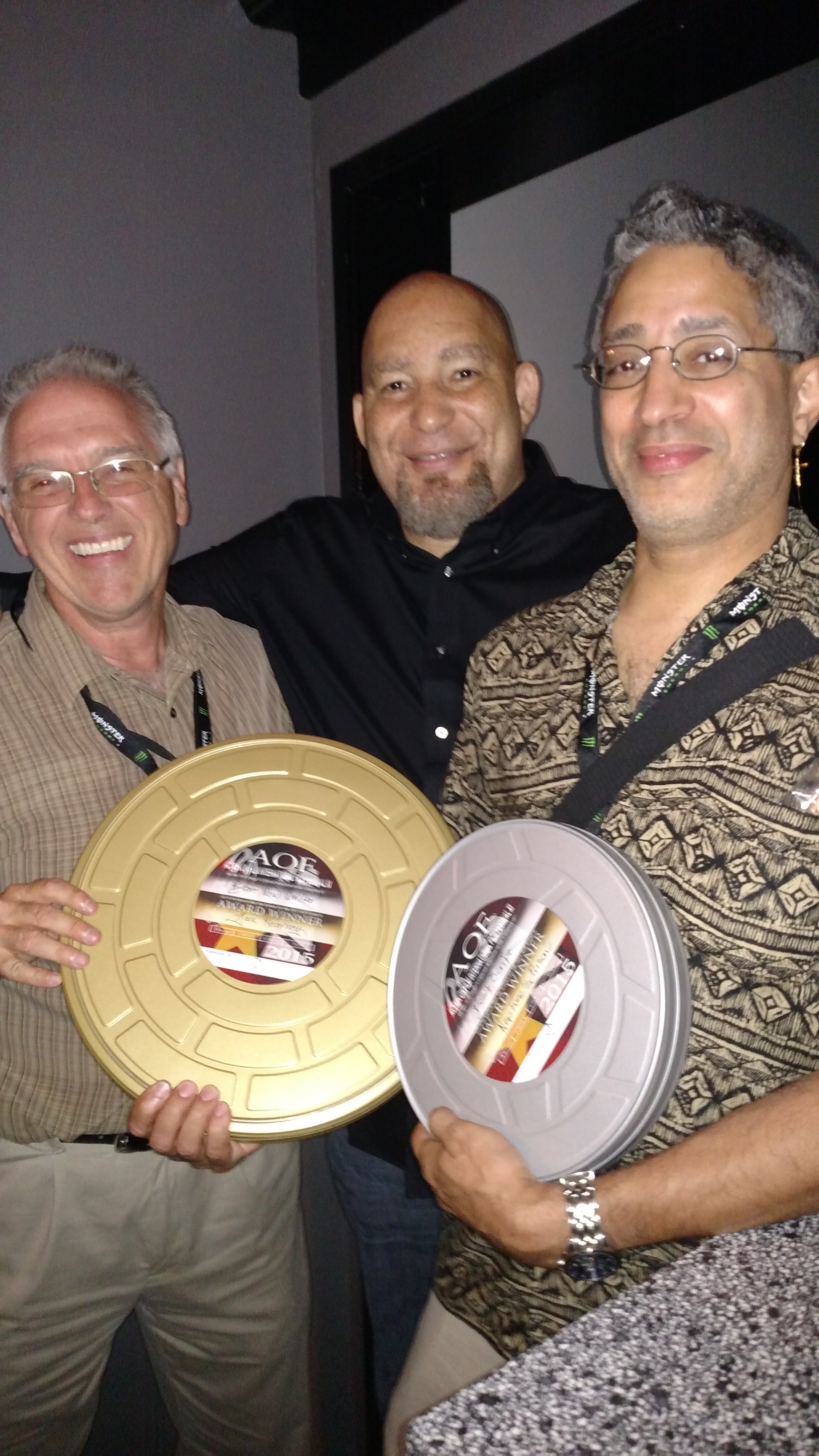 Writer Rob Tobin, Festival Director Del Weston, and Jax Kearney with his awards at the 2015 Action on Film Festival.