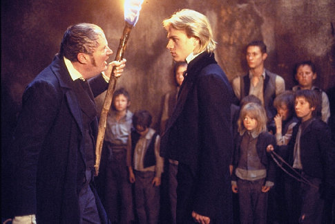 Nicholas Nickleby (CHARLIE HUNNAM) tries to protect the Dotheboys Hall orphans from Wackford Squeers (JIM BROADBENT)