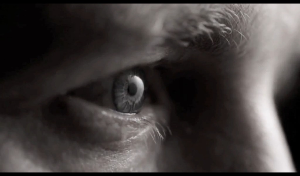 Still of Dean Dawson with an eye for craftsmenship in this Simmons Mattress commercial.