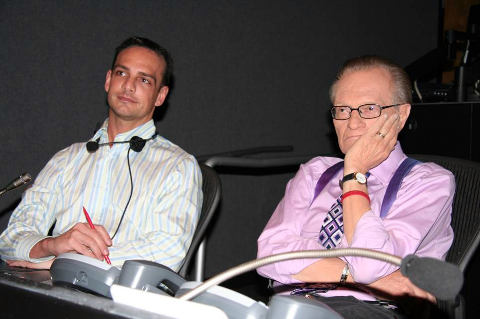 Greg Christensen & Larry King review news footage in the CNN Los Angeles control room