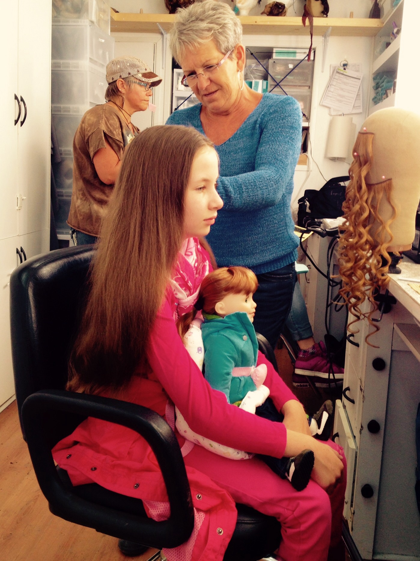 Malia Ashley Kerr with doll, Jenna in make-up trailer on set of Hell on Wheels.