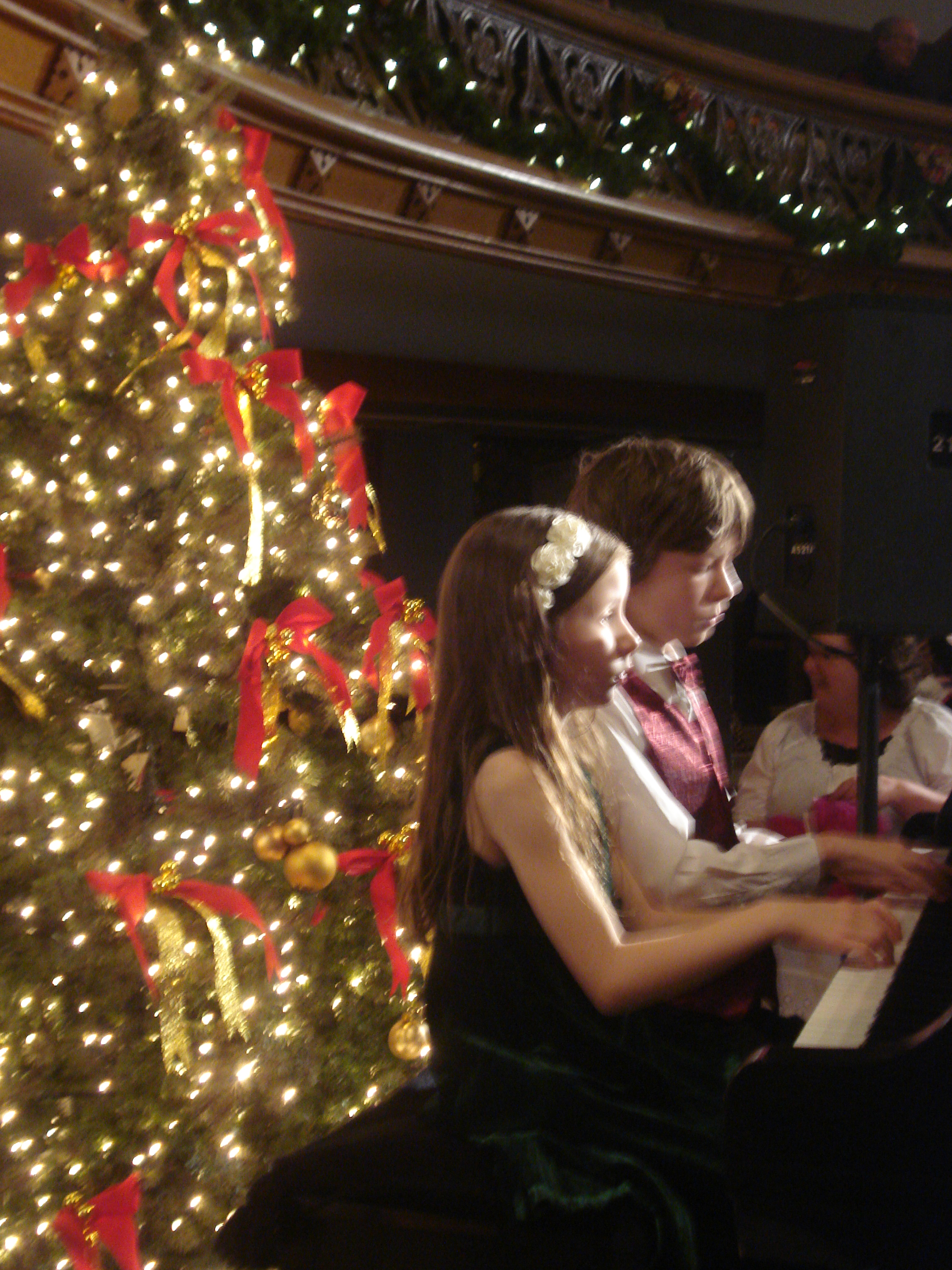 Professional pianists Malia and her brother Christian (Laurian Kerr) playing at W. Brett Wilson's annuual Christmas event.
