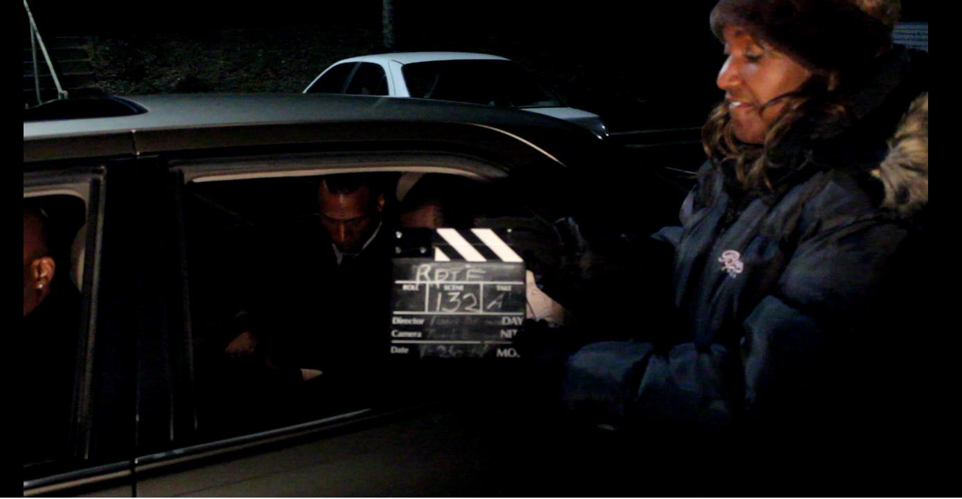 Film Producer Ton'e Brown directing a movie scene to the film 