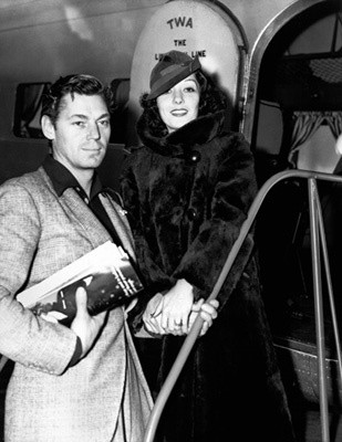 Johnny Weissmuller at the airport in California to see Lupe Velez, his wife, off on the trip to New York 12-09-1935