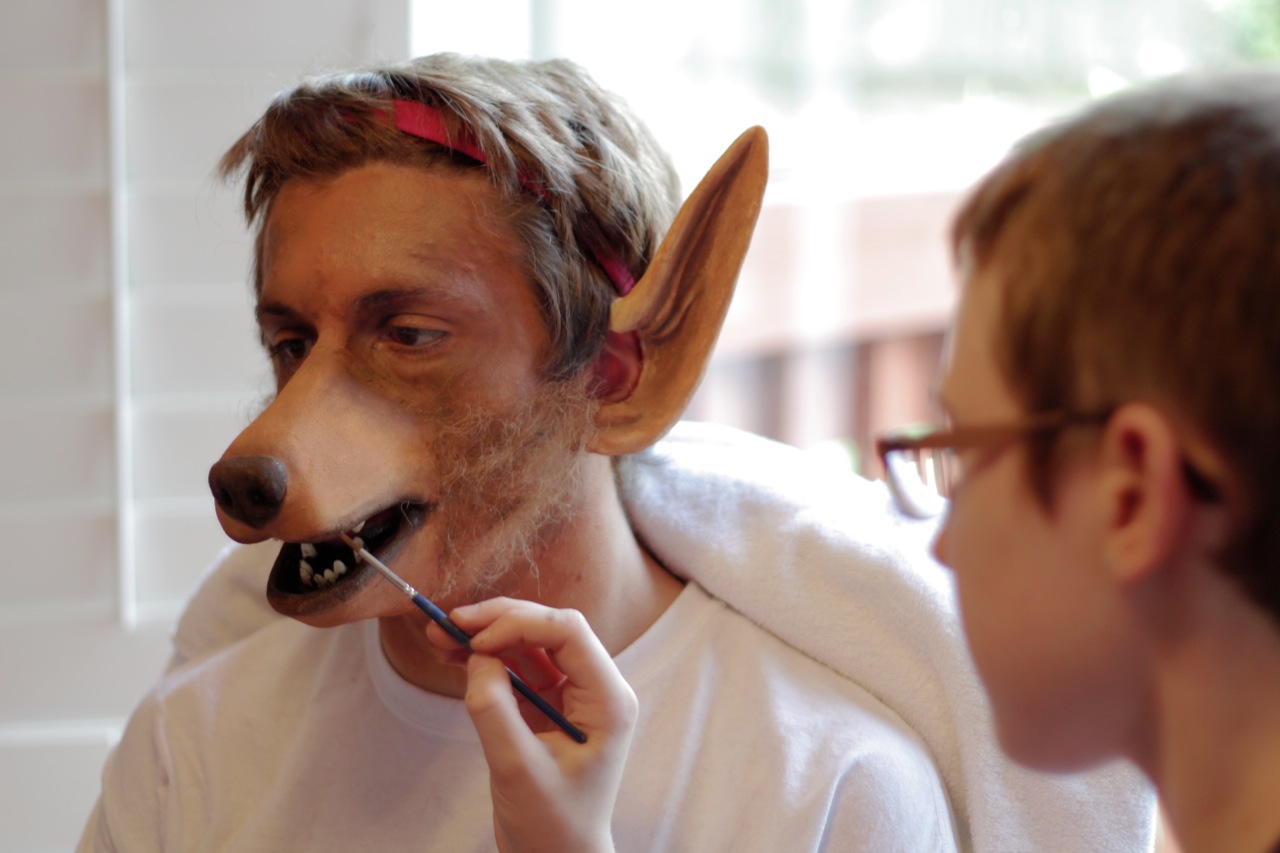 Morgana McKenzie applying makeup and paint to a prosthetic appliance on Connor Adsett for the production 