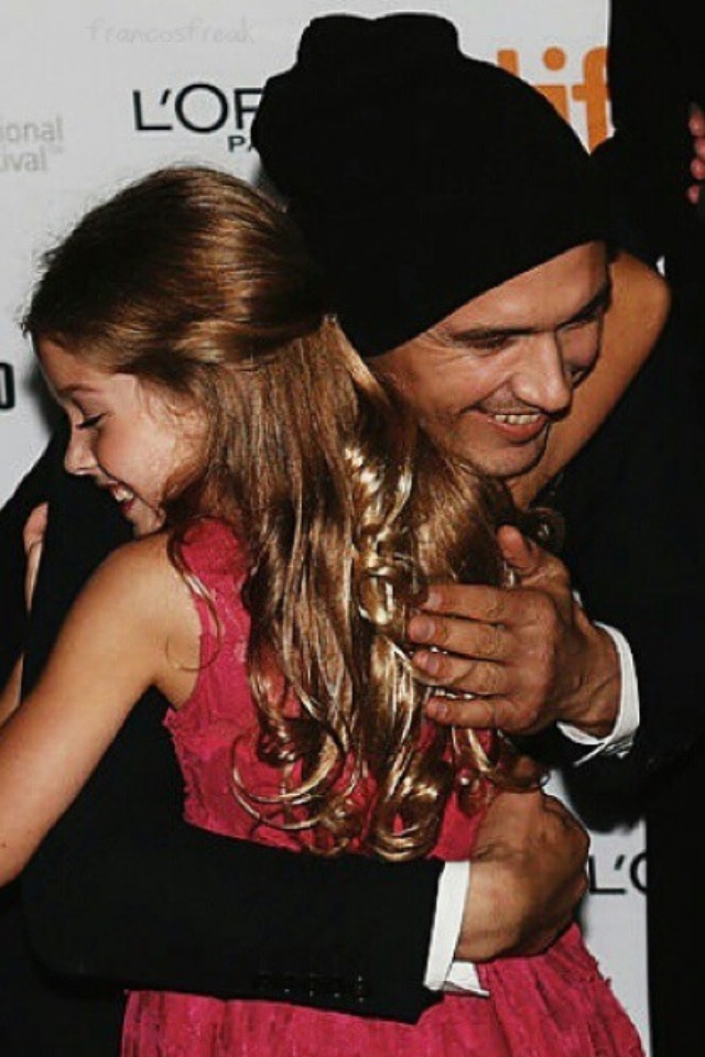 Stella Allen getting a hug from James Franco at the Toronto International Film Festival (2014)