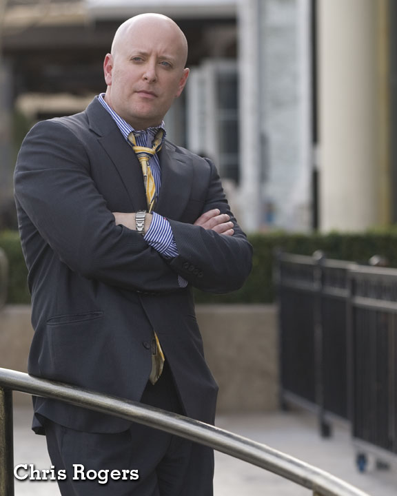 Chris Rogers in blue suit (portrait).