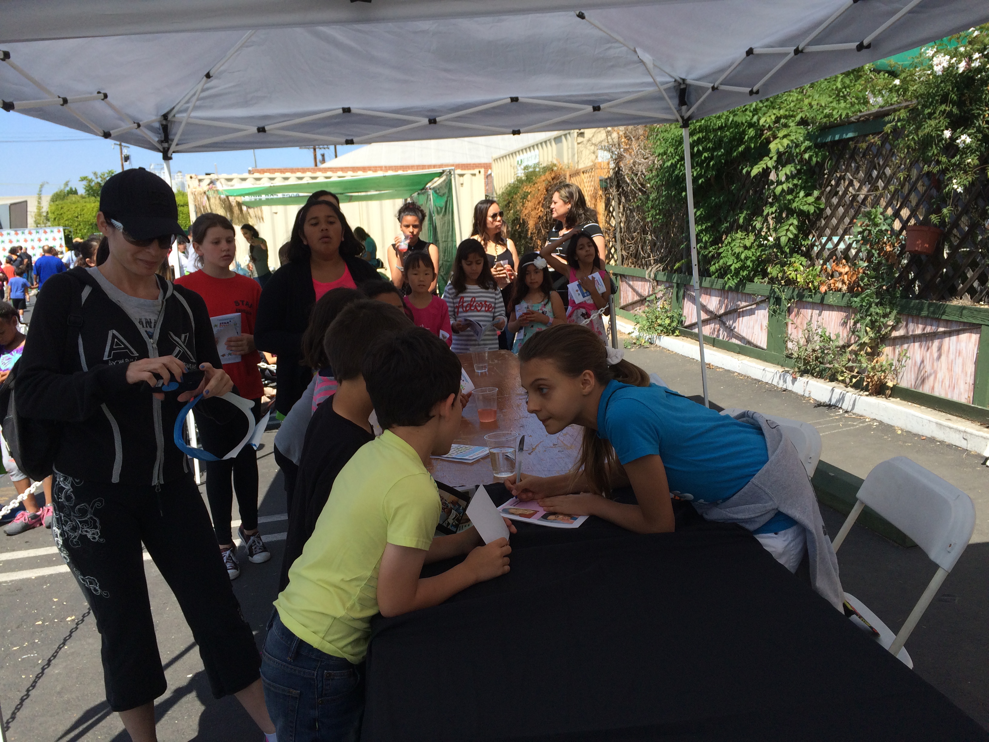 Masha Malinina signing autographs at Earth Day Green Carpet