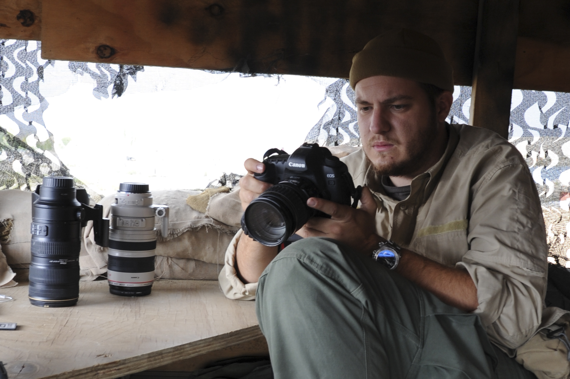 Robert L. Cunningham takes a moment to review footage during takes in Eastern Afghanistan, 2011.