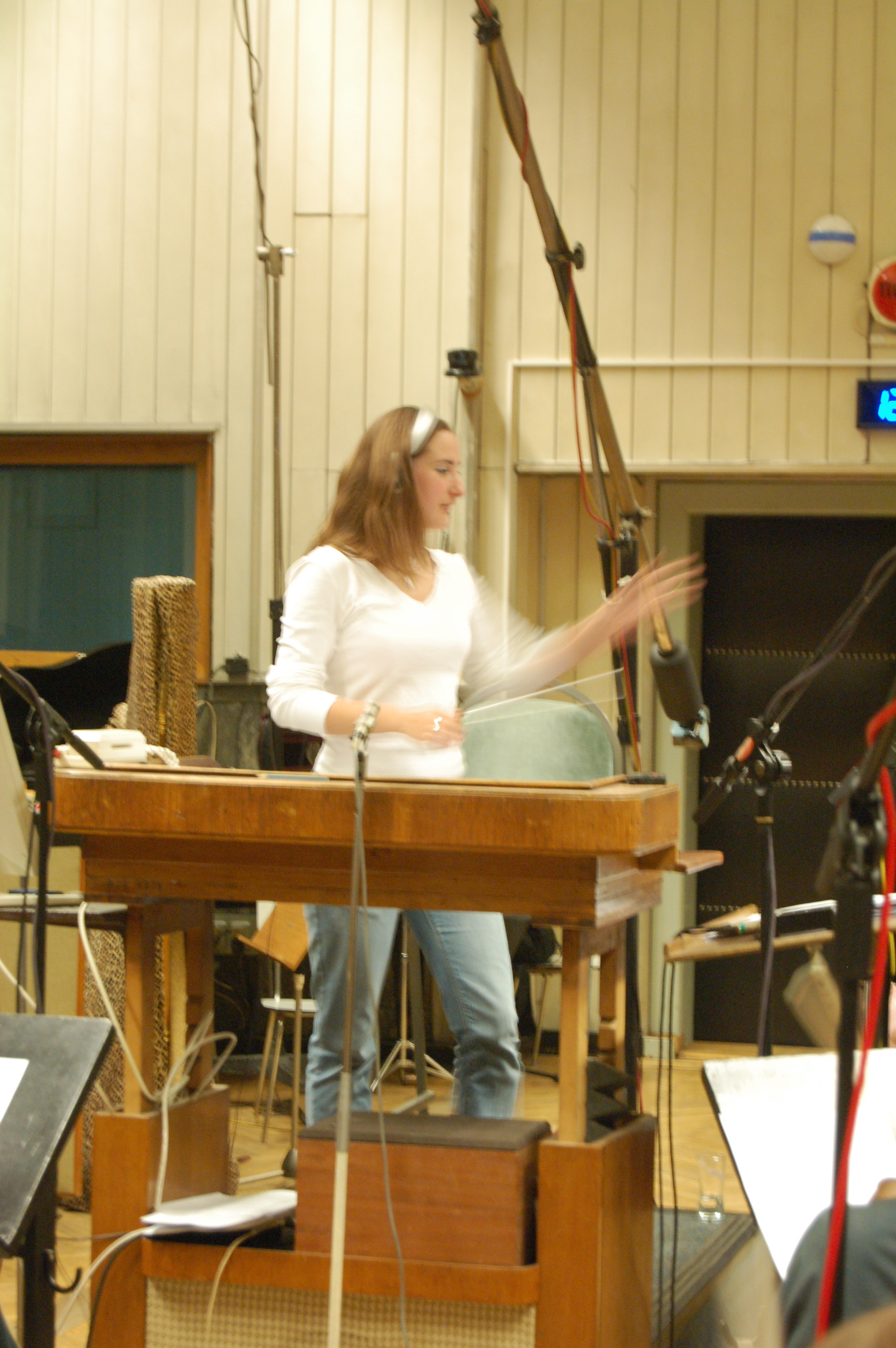 Rachel James conducting one of her scores with the City of Prague Philharmonic orchestra.